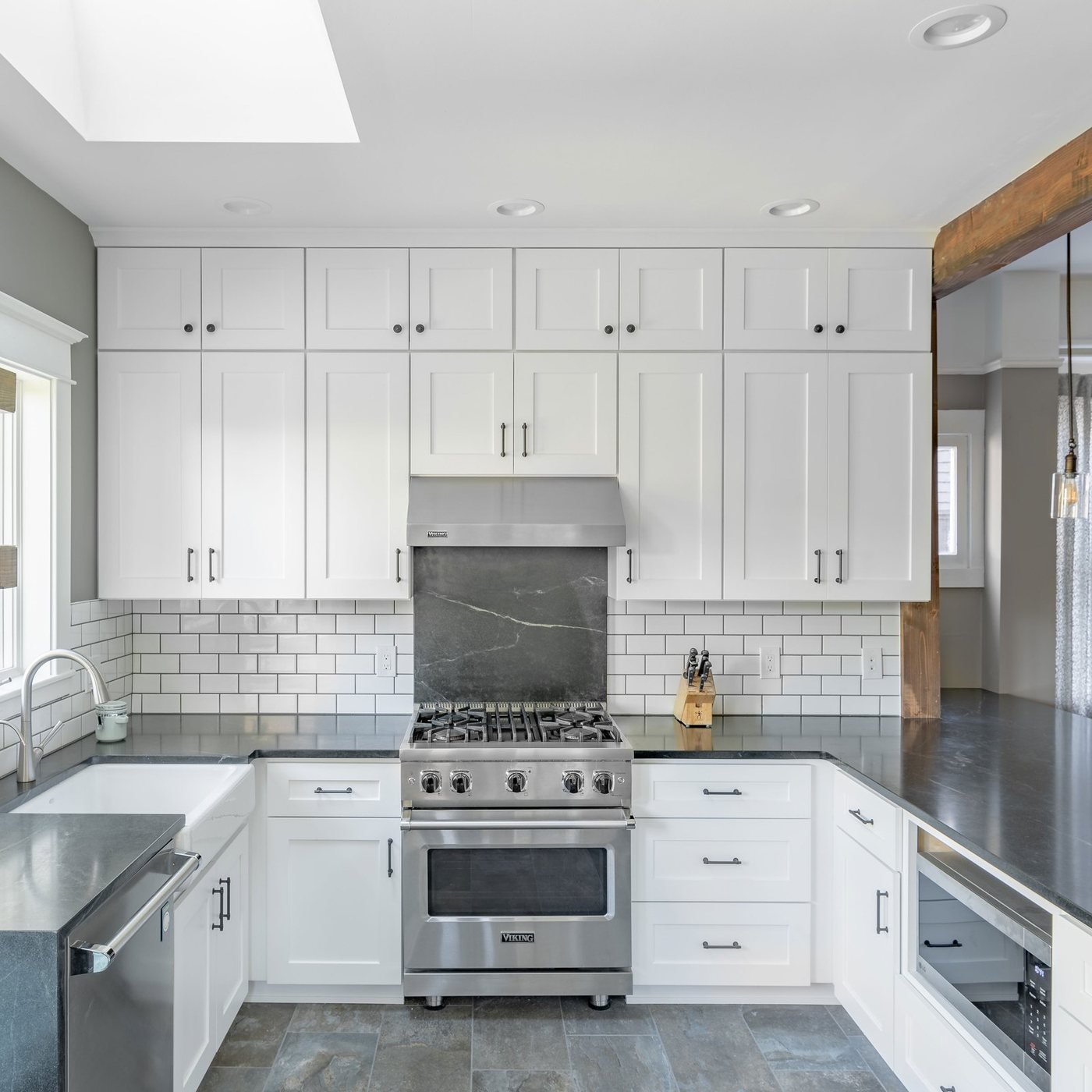 Two tone kitchen with open shelving and subway tile backsplash
